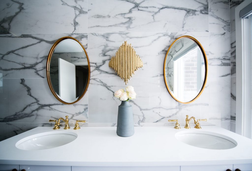 Photo of a double-vanity bathroom with marble textures