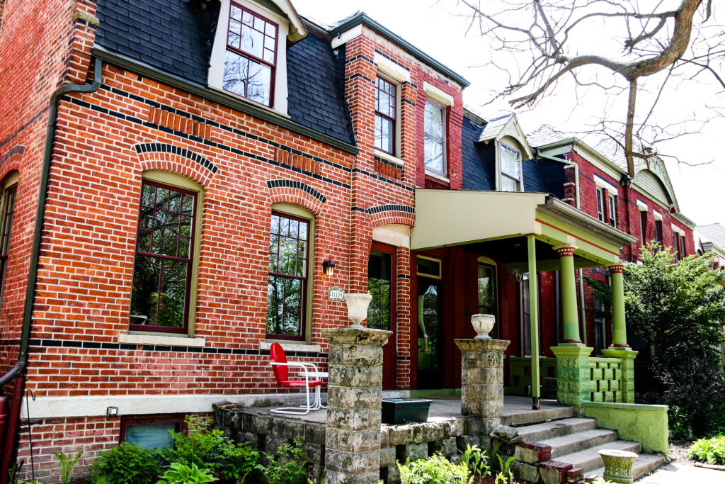 The exterior of townhouses made of brink shine bright from the sun.